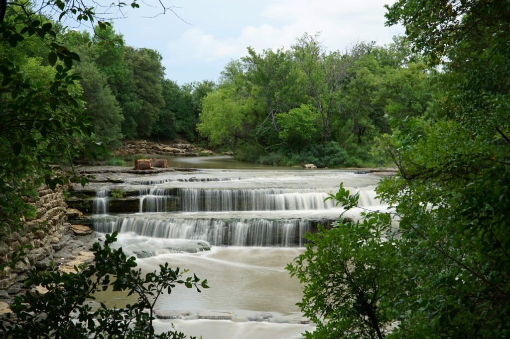 Scenic view of Tarrant County's largest natural waterfall, Airfield Falls, located just minutes from Azle and perfect for weekend nature hikes.