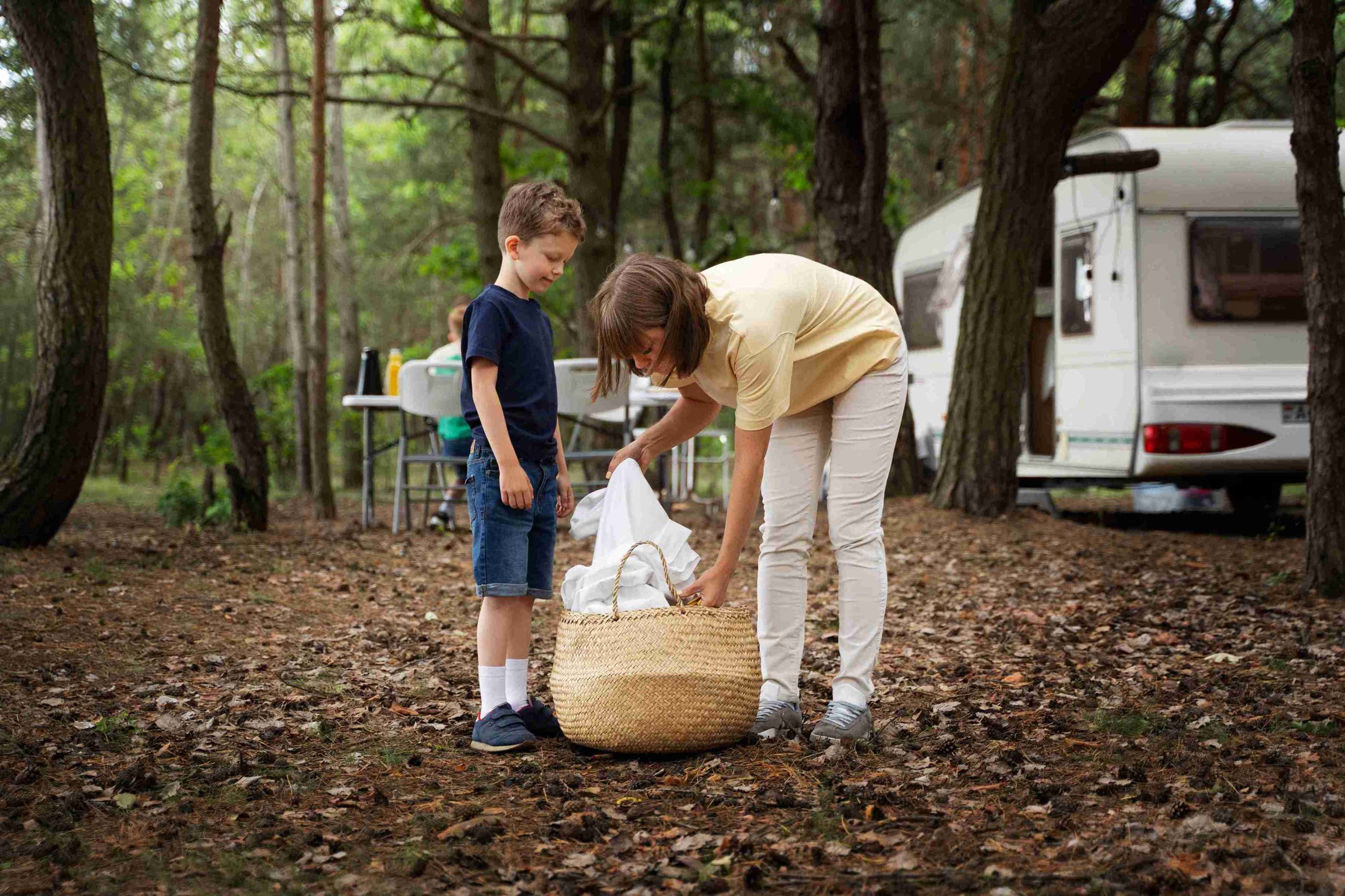 Spring RV camping checklist for Texas with weather gear, layers, rain jacket, and water activity equipment laid out